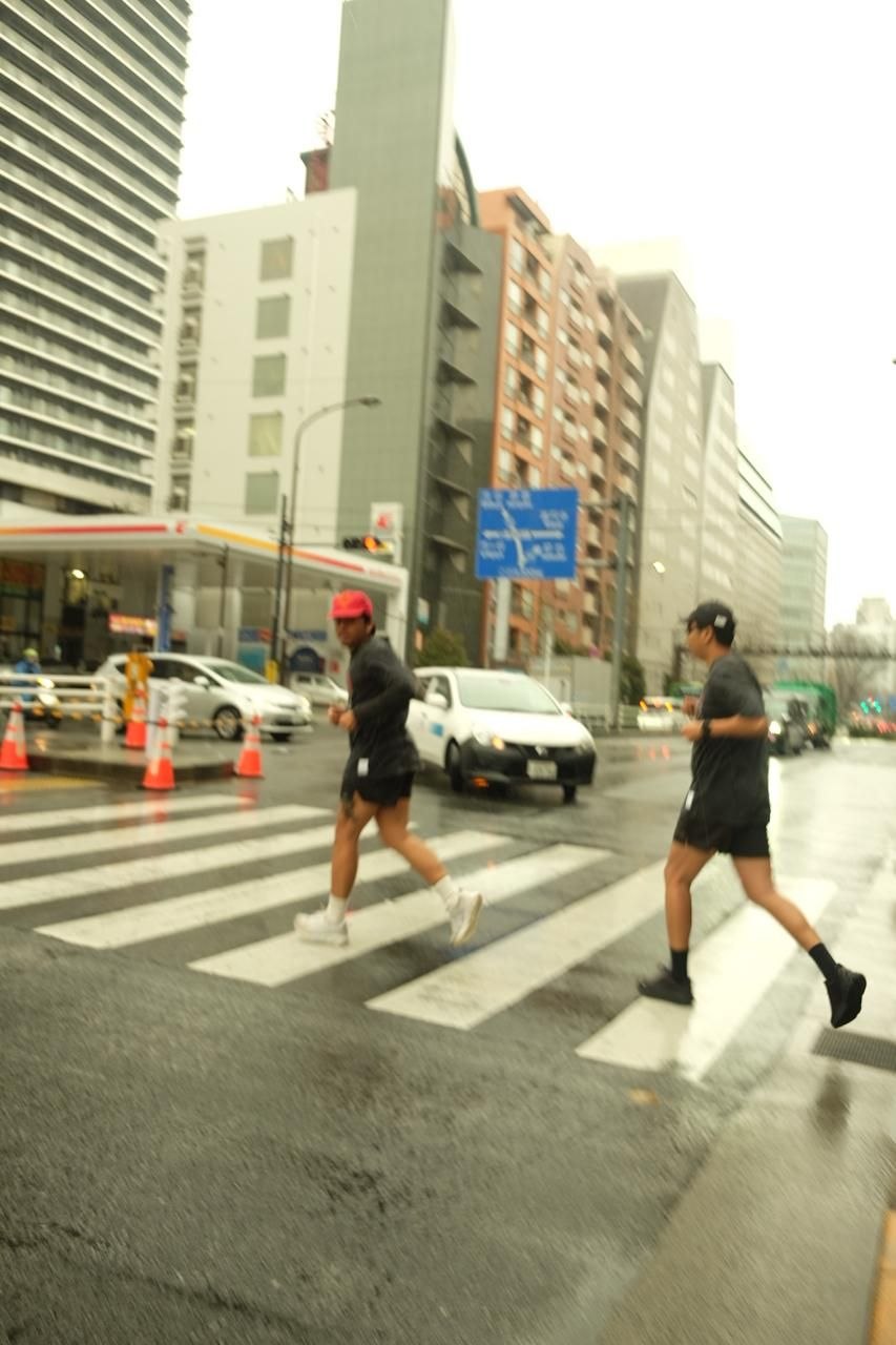 Runner crossing a city intersection